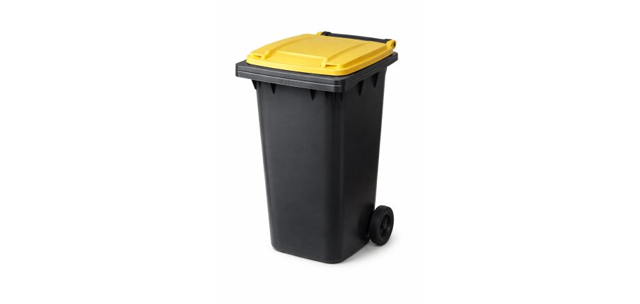 Auf dem Bild ist eine schwarze Mülltonne mit gelben Deckel zu sehen